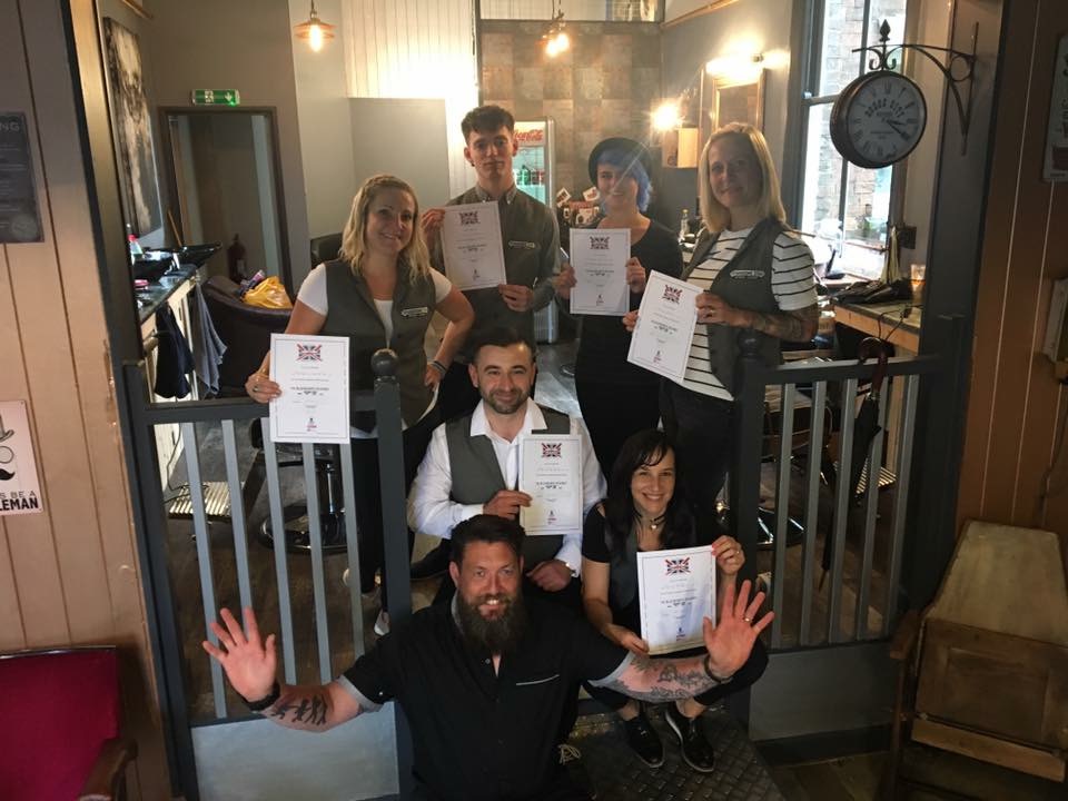 A group of people holding certificates