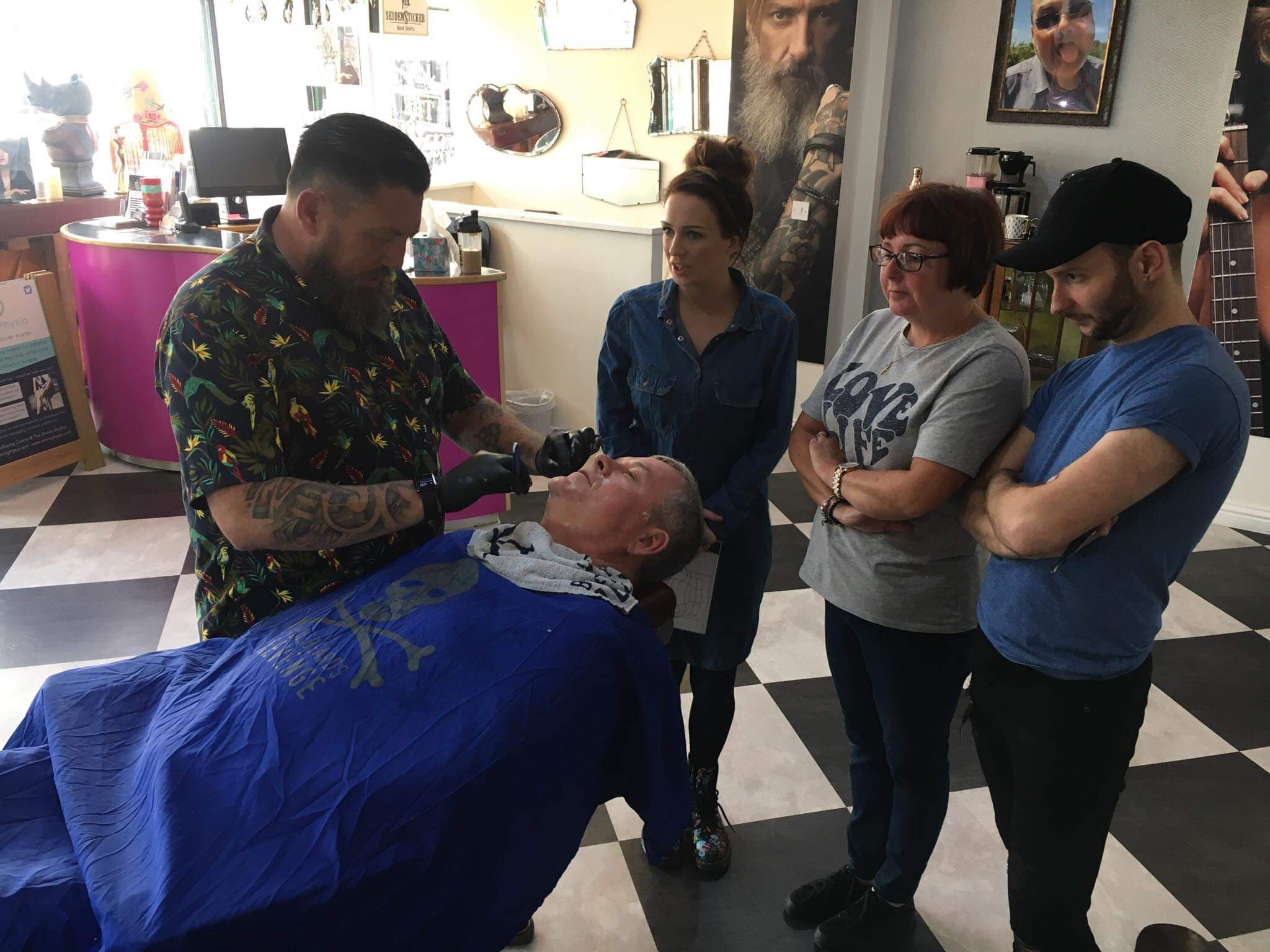A barbering demonstration with people watching