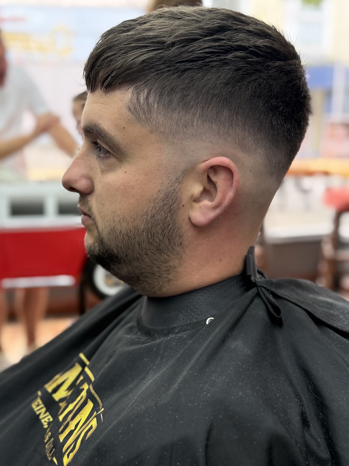 French crop haircut with a trimmed beard