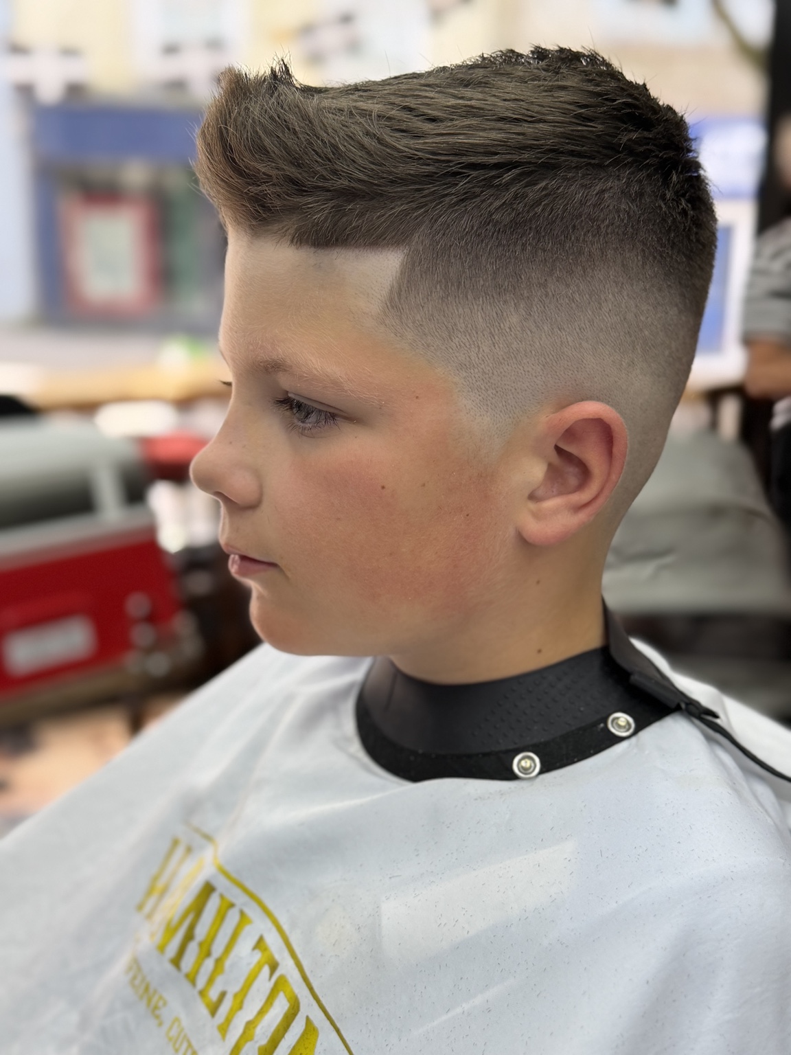 Textured haircut with a skin fade on a teenager