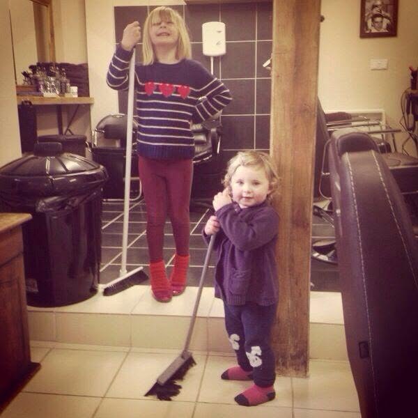 Sophie and Emily with brooms inside the first Hamilton's shop in February 2014
