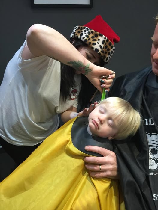 A young customer having a haircut inside the top shop at 51 Fore Street