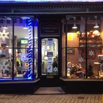 The first Hamilton's shop at Cross Street, Redruth, lit up at night